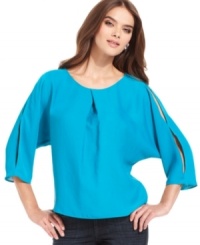 Cutout details up the edge on this boxy RACHEL Rachel Roy blouse for an urban-chic look!