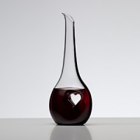 For over 250 years, Riedel Crystal's collections have become known for pushing the limits; offering ground-breaking ideas and award winning designs that enhance wine enjoyment. Bliss displays an off-center heart stamped from each side, compressing the crystal into a thin pane of solid glass. This innovative design provides a place for the fingers to rest as the wine flows out of the decanter into a waiting glass. Bliss is dressed up with a black tuxedo stripe that extends gracefully from top to bottom. For over 250 years, Riedel Crystal's collections have become known for pushing the limits; offering ground-breaking ideas and award winning designs that enhance wine enjoyment. Bliss displays an off-center heart stamped from each side, compressing the crystal into a thin pane of solid glass. This innovative design provides a place for the fingers to rest as the wine flows out of the decanter into a waiting glass. Bliss is dressed up with a black tuxedo stripe that extends gracefully from top to bottom.