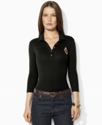 Sleek gold-toned buttons and a metallic embroidered crest lend regal elegance to Lauren Ralph Lauren's soft cotton polo shirt. Sleek gold-toned buttons and a metallic embroidered crest lend regal elegance to Lauren Ralph Lauren's soft cotton polo shirt.
