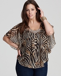 A vibrant swirl of tiger stripes enlivens this sheer Karen Kane Plus top, finished with a beaded neckline for a glamorous walk on the wild side. A vibrant swirl of tiger stripes enlivens this sheer Karen Kane Plus top, finished with a beaded neckline for a glamorous walk on the wild side.
