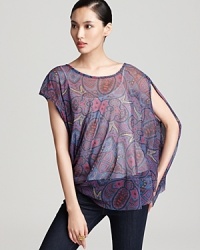 This sheer paisley printed Sweet Pea top lends an edgy asymmetrical shape and ethereal layer over a classic cami. This sheer paisley printed Sweet Pea top lends an edgy asymmetrical shape and ethereal layer over a classic cami.