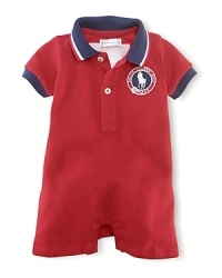 A preppy short-sleeved polo shortall in breathable stretch cotton mesh is accented with USA patching, celebrating Team USA's participation in the 2012 Olympics. A preppy short-sleeved polo shortall in breathable stretch cotton mesh is accented with USA patching, celebrating Team USA's participation in the 2012 Olympics.