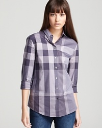The iconic check print makes a bold impression on a classic Burberry Brit shirt for chic everyday attitude. The iconic check print makes a bold impression on a classic Burberry Brit shirt for chic everyday attitude.