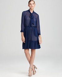 One part polished, two parts playful, this DKNY dress flaunts a flowing, sheer silhouette interrupted by a delicately ruffled hemline. One part polished, two parts playful, this DKNY dress flaunts a flowing, sheer silhouette interrupted by a delicately ruffled hemline.