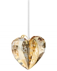 Goldtone metal pierced with intricate patterns and sparkling chatons adds even more splendor to this exquisite Swarovski crystal heart ornament. Goldtone metal pierced with intricate patterns and sparkling chatons adds even more splendor to this exquisite Swarovski crystal heart ornament.