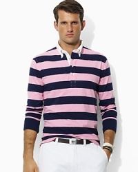 Bold, preppy stripes lend a heritage appeal to a relaxed-fitting polo shirt, crafted from lightweight cotton mesh for a breathable wear. Bold, preppy stripes lend a heritage appeal to a relaxed-fitting polo shirt, crafted from lightweight cotton mesh for a breathable wear.