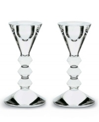 The timeless appeal of crystal for modern aesthetics. A deep beveled stem balances the dramatic symmetry of the cone-shaped top and bottom. The timeless appeal of crystal for modern aesthetics. A deep beveled stem balances the dramatic symmetry of the cone-shaped top and bottom.